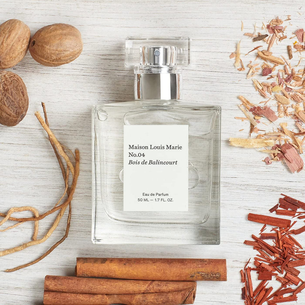Maison Louis Marie No.04 bottle with warm lighting emphasizing amber wood base note.