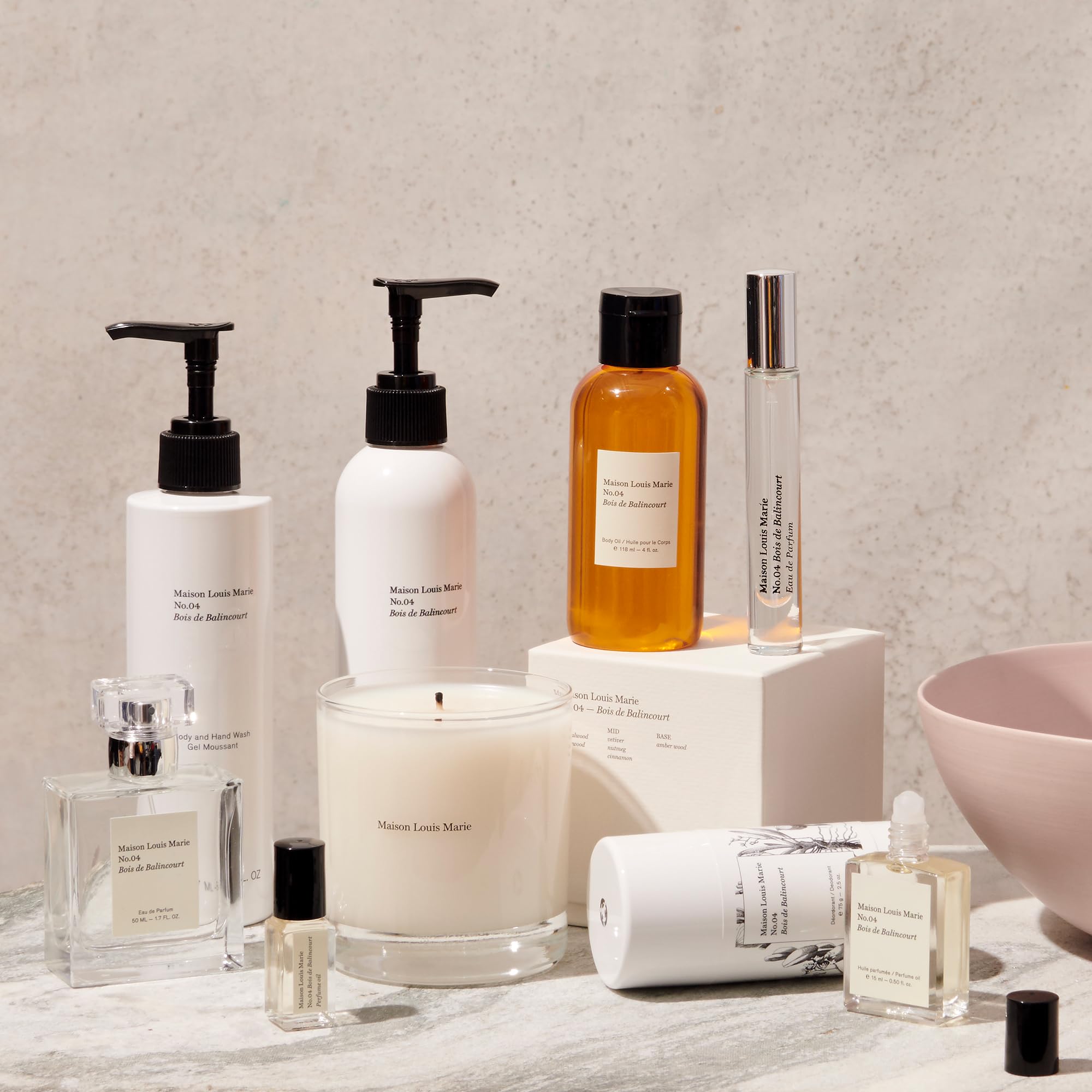 Hands applying Maison Louis Marie No.04 Bois de Balincourt lotion for smooth, layered fragrance.