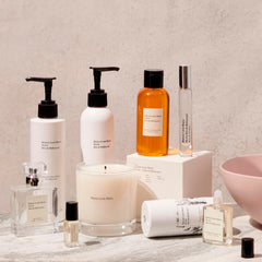 Hands applying Maison Louis Marie No.04 Bois de Balincourt lotion for smooth, layered fragrance.