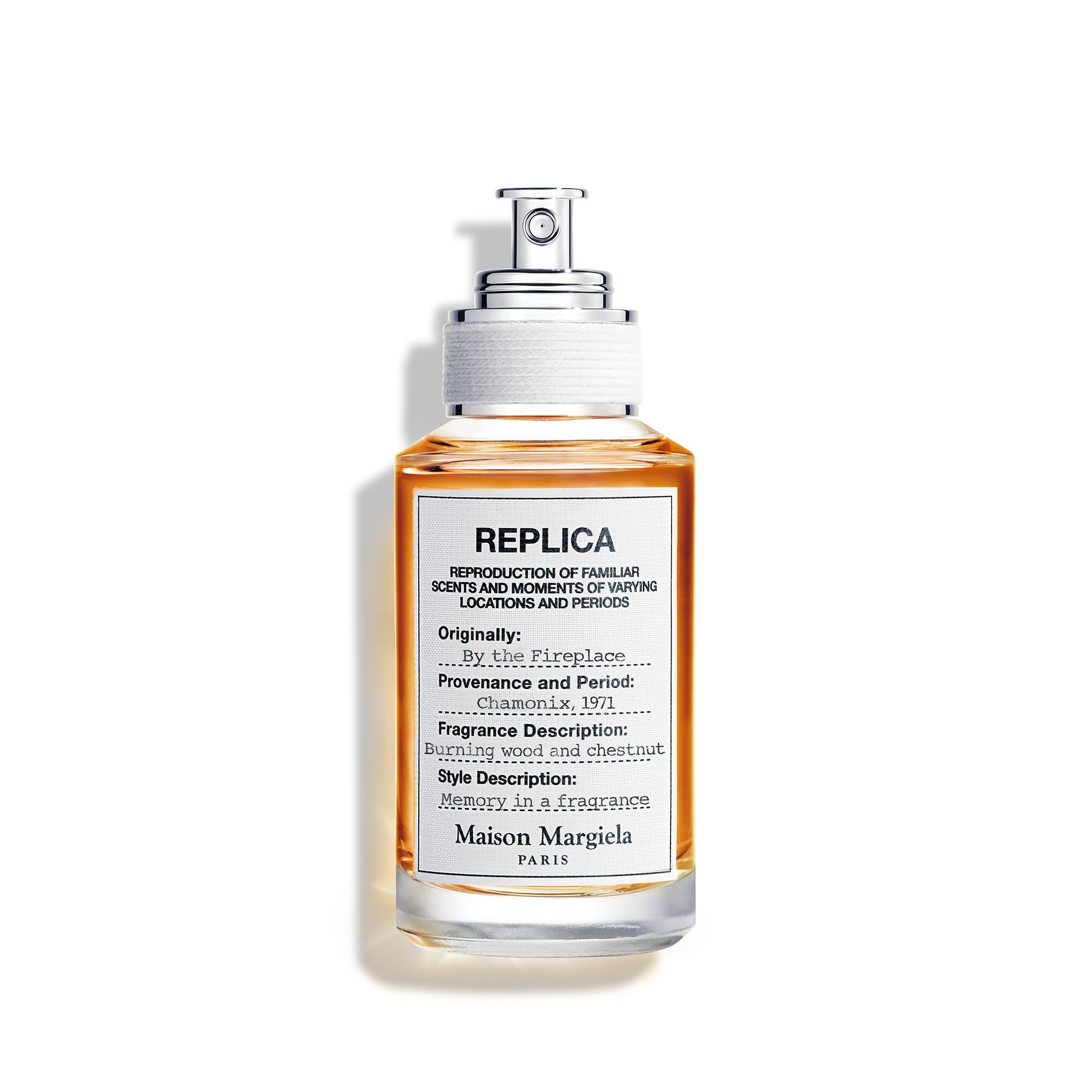 Maison Margiela Replica By the Fireplace bottle on a mantel, inviting warmth and ambience.