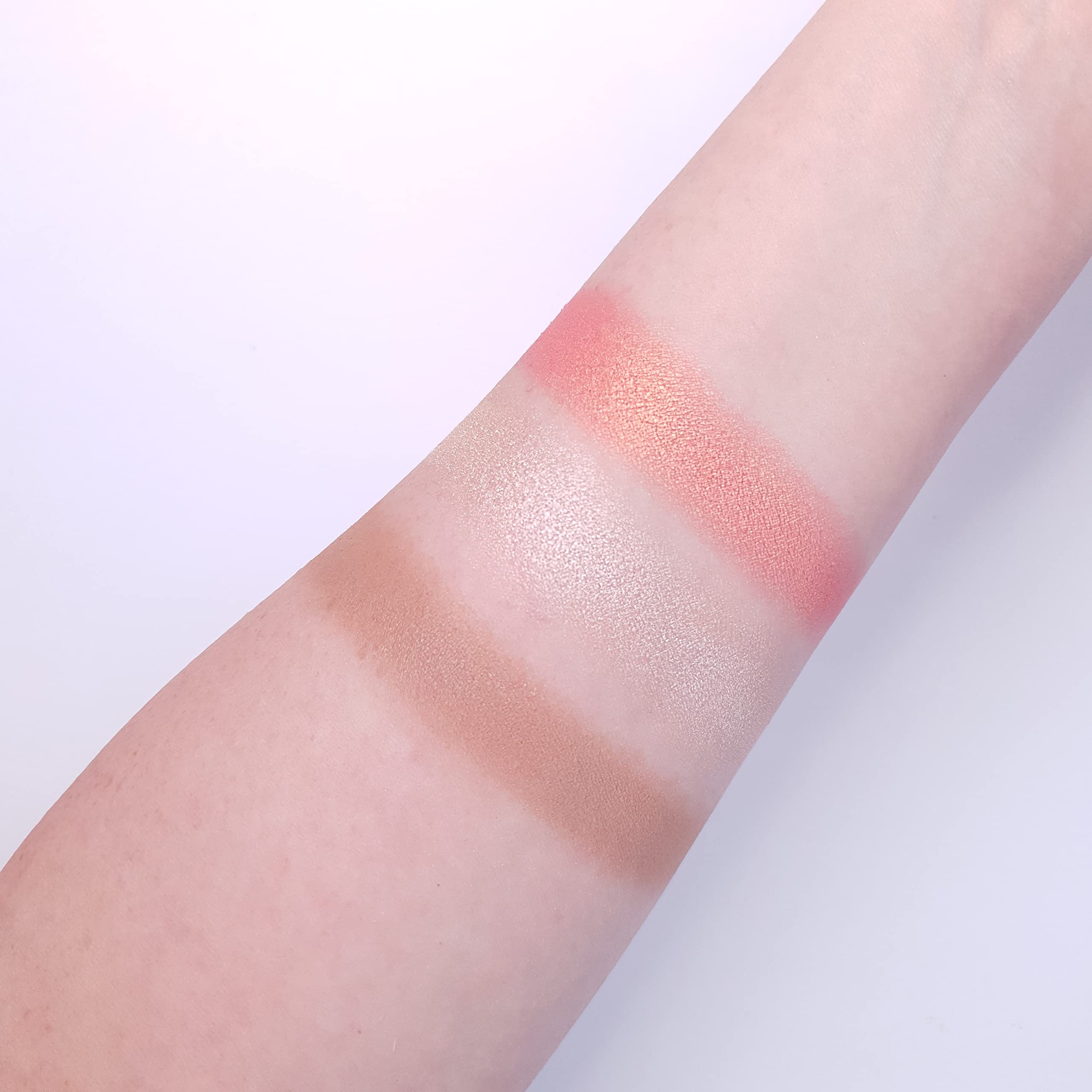 Makeup Revolution highlighter powder catches light for lifted cheekbones.