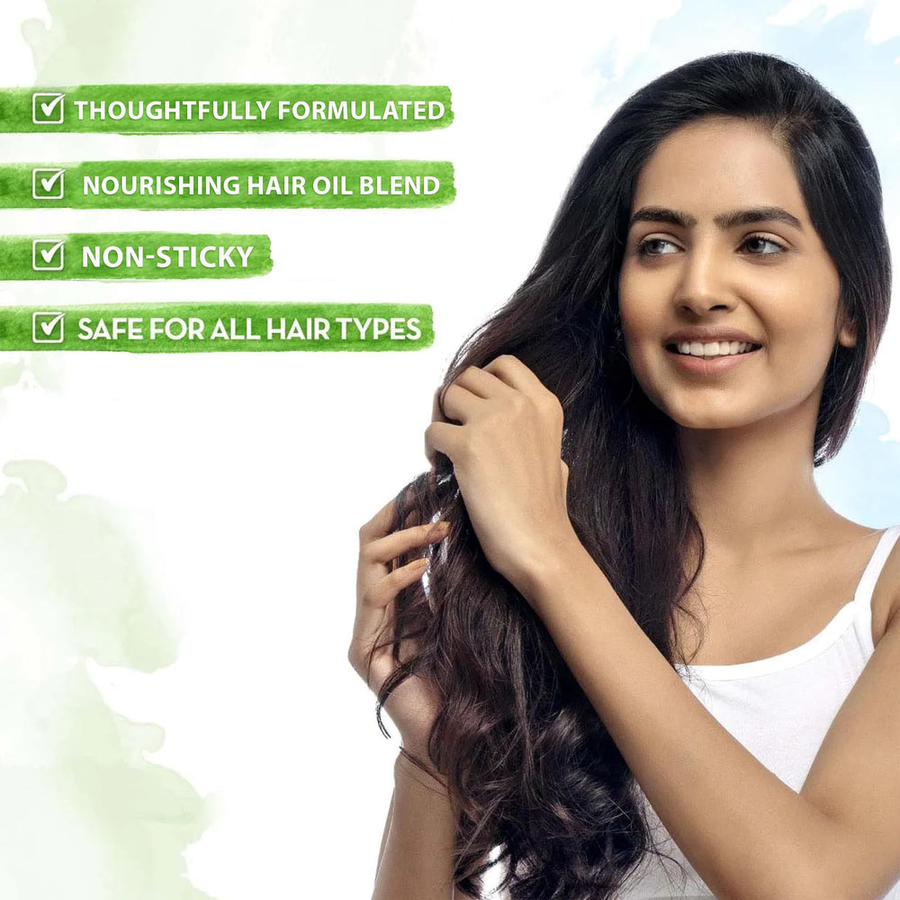Drop of Mamaearth Onion Hair Oil highlights its rich nourishing texture.