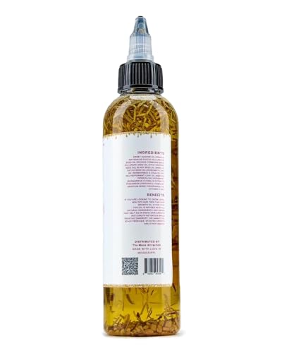 The Mane Attraction hair growth oil drop on hand showing easy daily application.