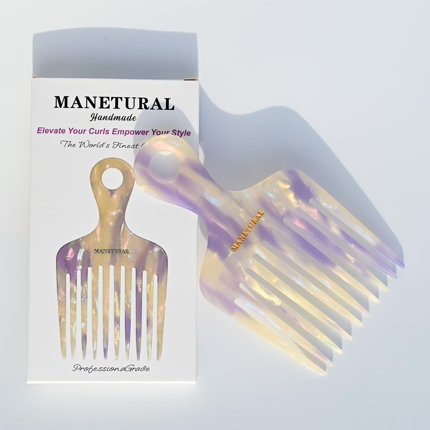 ManetURAL hair pick in use on curly Afro textures, lift and volume