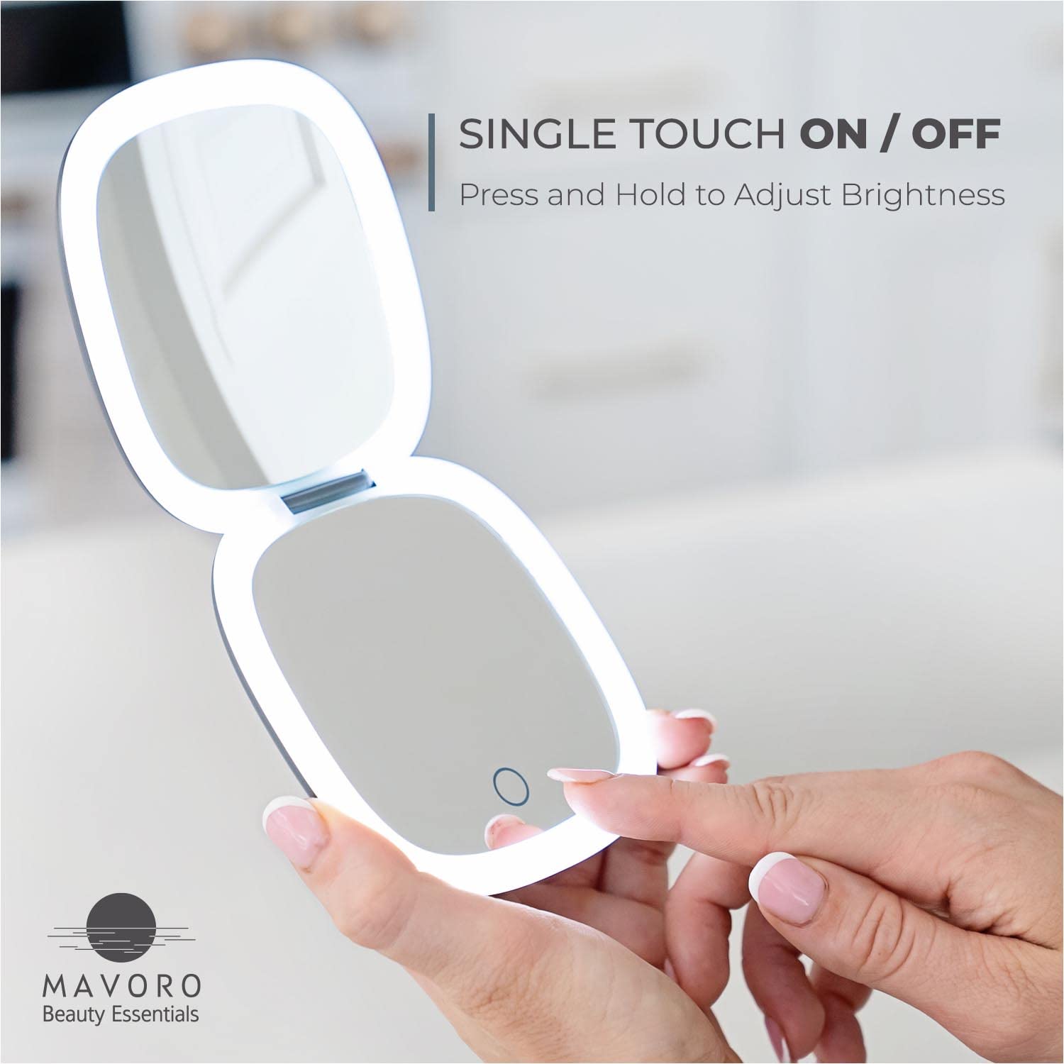 Mavoro graphite grey travel mirror in hand for on-the-go touchups.