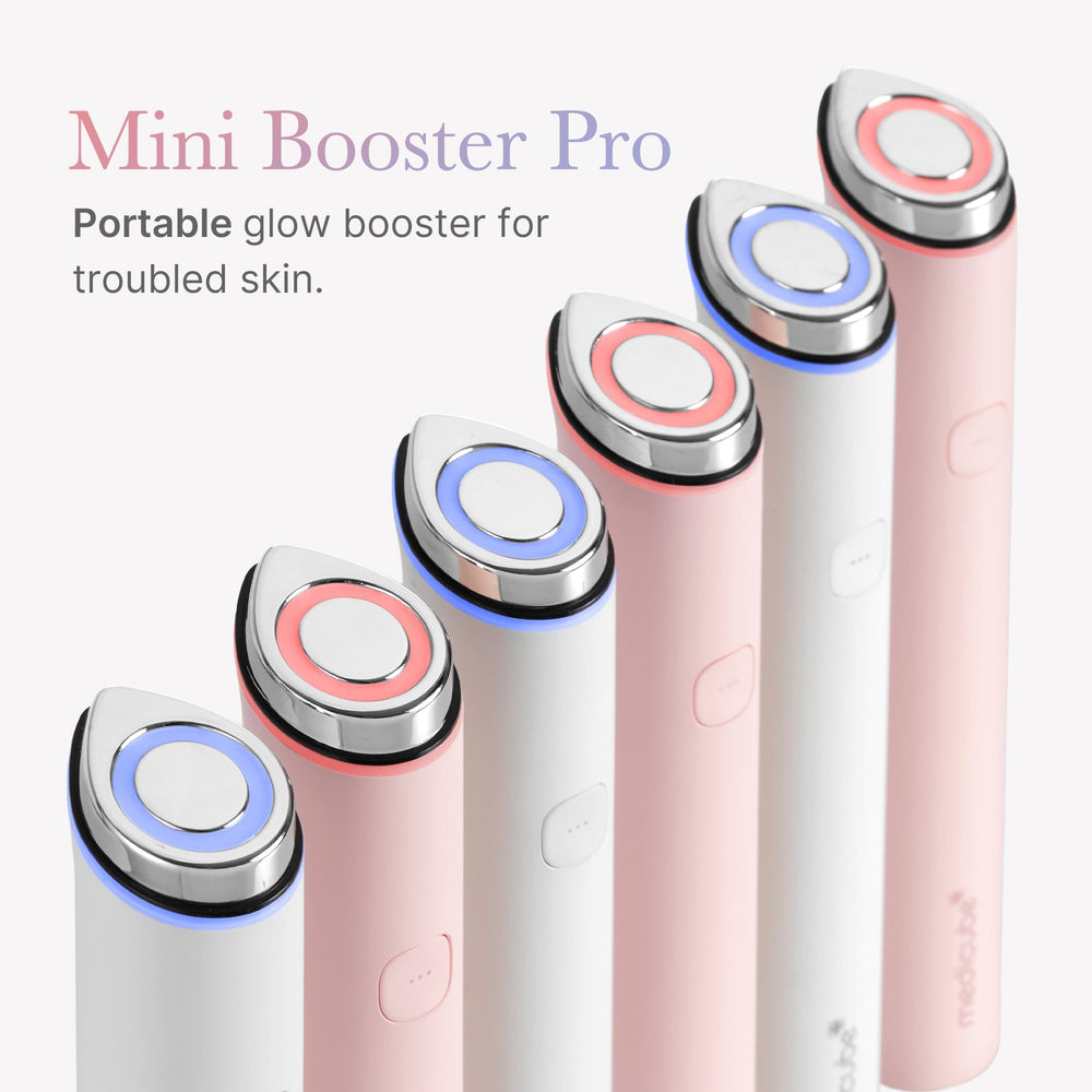 Medicube Mini Booster Pro White in-hand demonstrates portable skin care on the go
