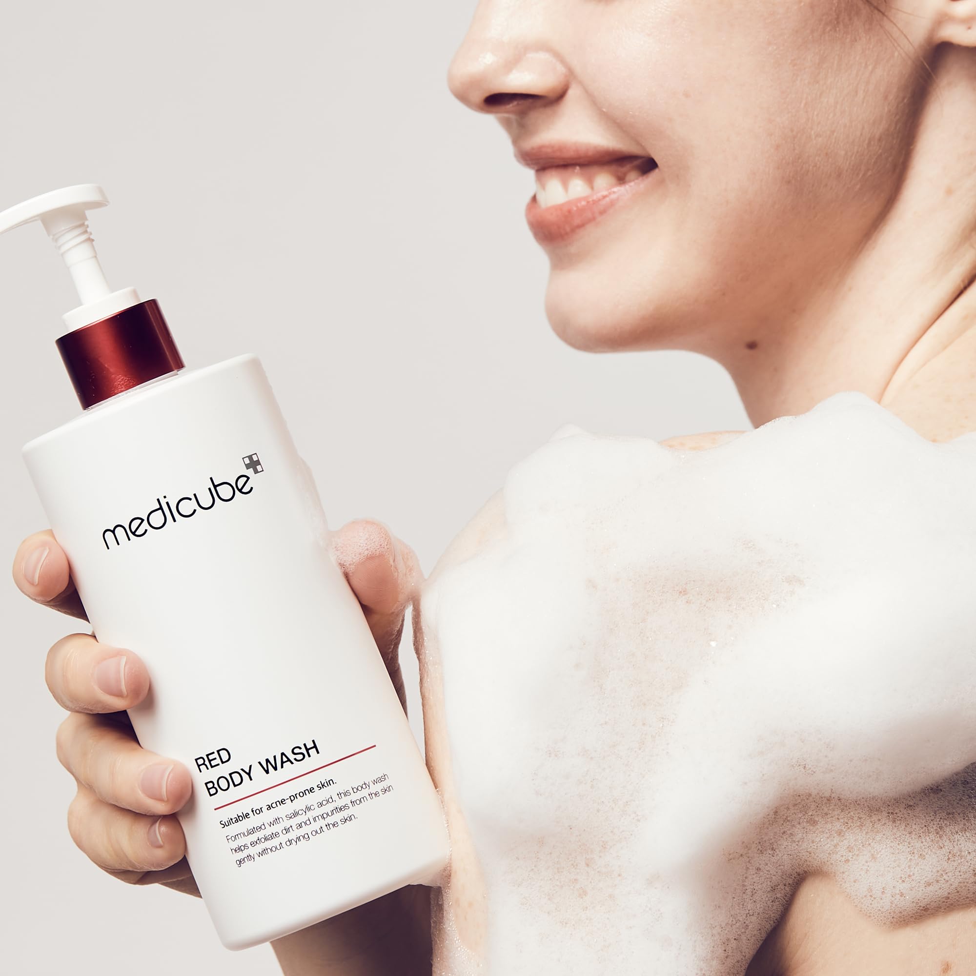 Medicube Red Body Wash pours into hand illustrating rich lather for hydration.