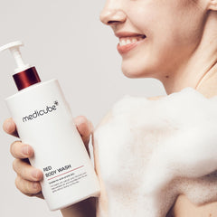 Medicube Red Body Wash pours into hand illustrating rich lather for hydration.