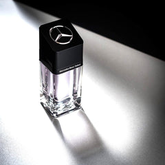 Mercedes-Benz Select bottle on desk with blue accents conveys luxury and confidence