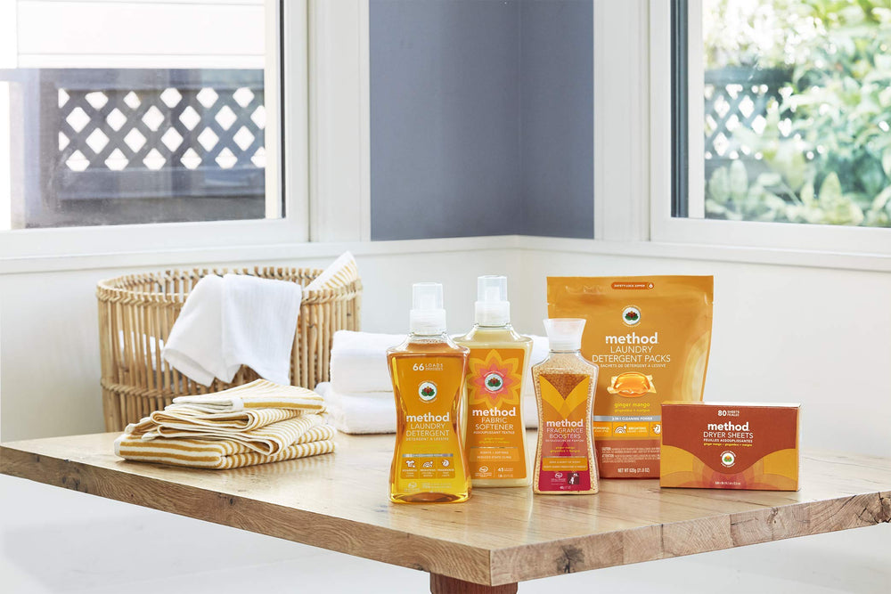 Method Fragrance Booster Ginger Mango in a laundry room scene with crisp sheets