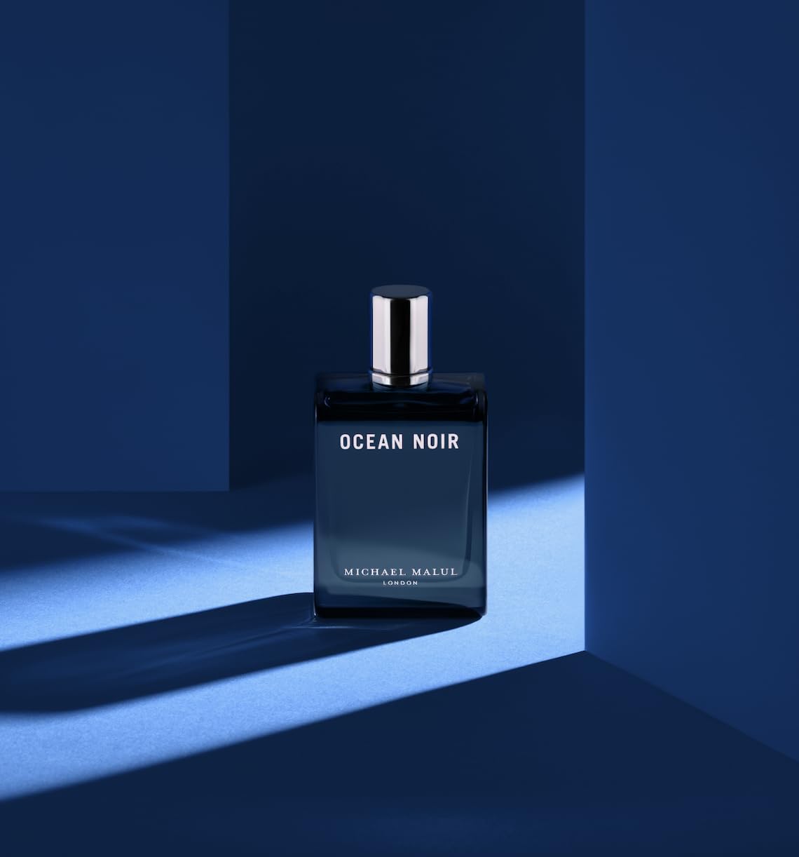 Iconic blue-tinted cap and sleek bottle profile for premium fragrance display.