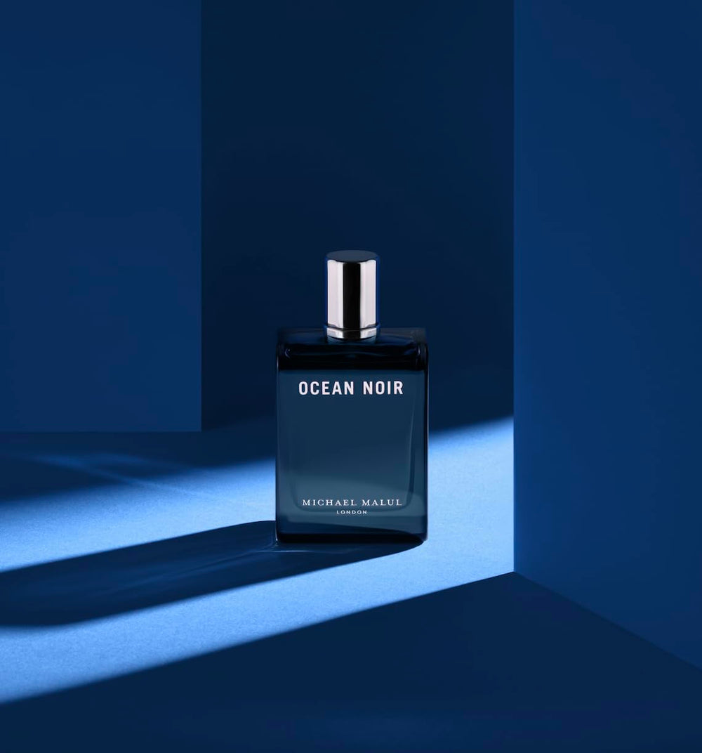Iconic blue-tinted cap and sleek bottle profile for premium fragrance display.