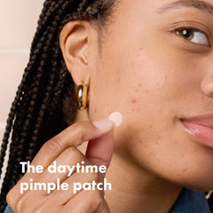 Mighty Patch Invisible+ patch on zit close-up demonstrating near-invisible coverage.