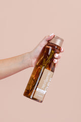 Milagros red onion extract shampoo closeup highlights nourishing ingredients for healthy roots.