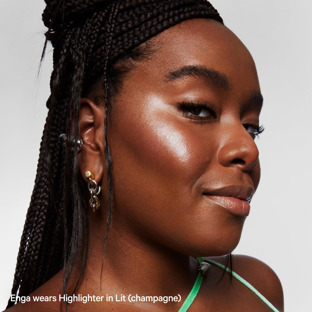 Milk Makeup Lit champagne glow on Cupid’s bow for accent.