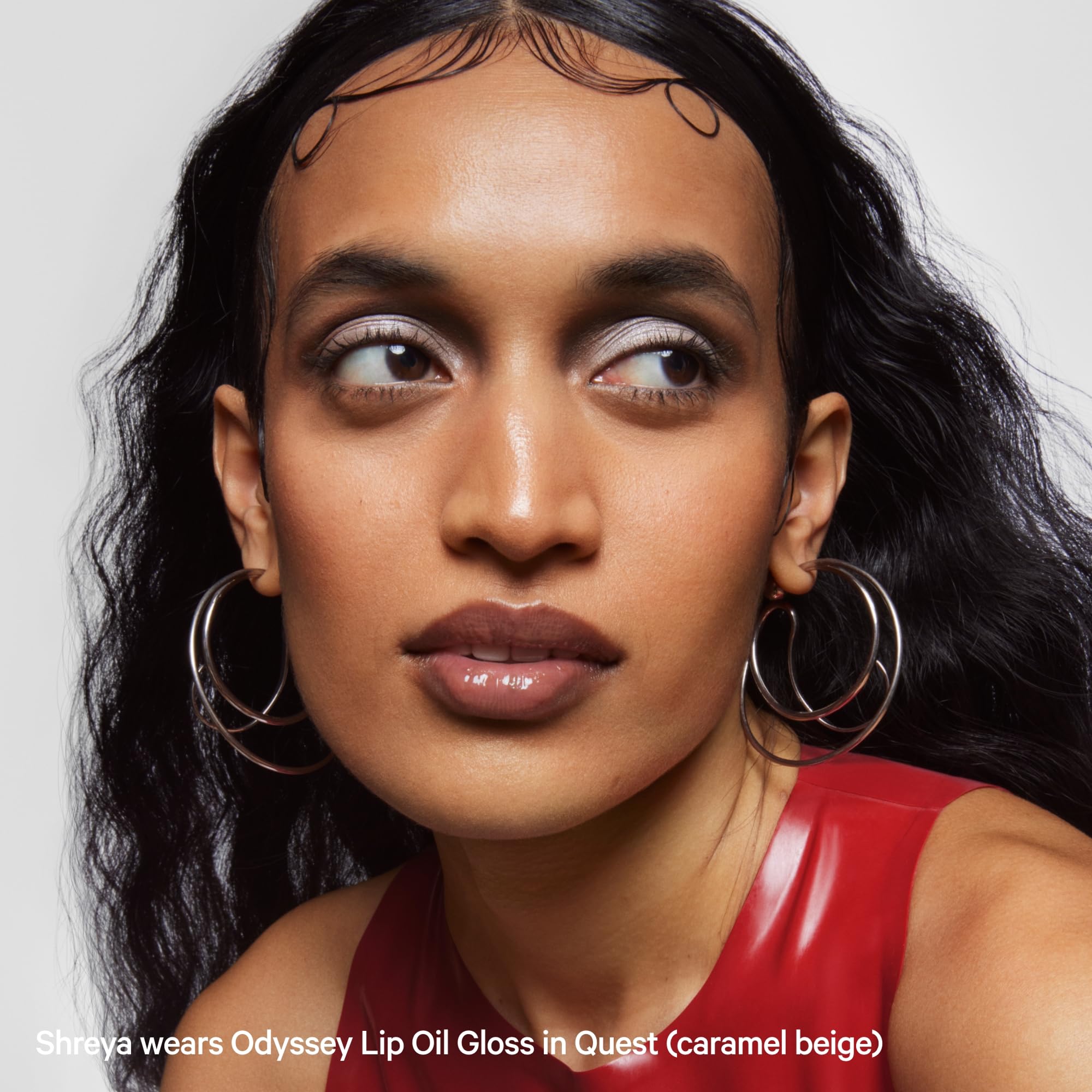 Milk Makeup Odyssey Lip Gloss Quest close-up reveals true caramel beige tone with hydration.