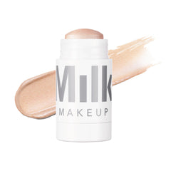 Milk Makeup Turnt highlighter on cheekbone for radiant illumination.