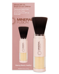 Mineral Fusion brush-on sunscreen compact close-up with translucent matte finish for daily wear.