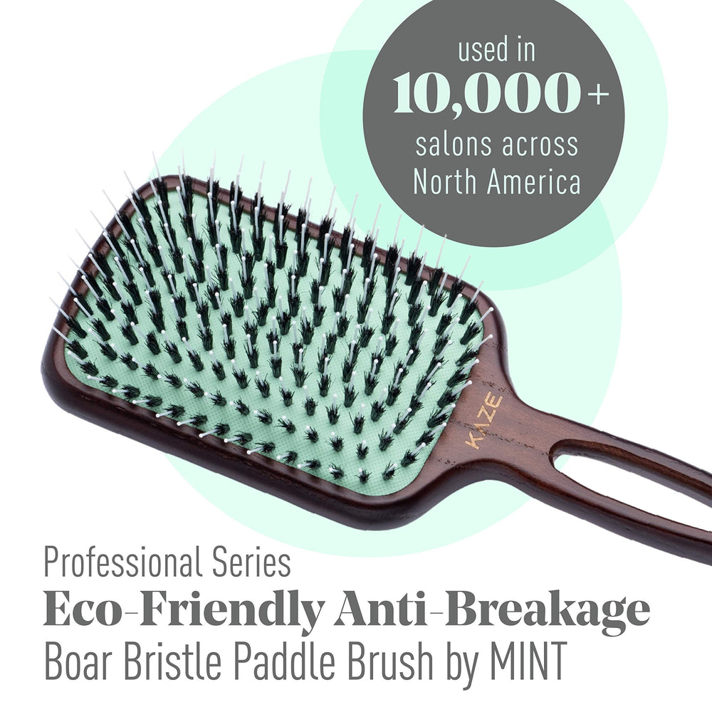 Mint wooden-handle paddle brush detail shows hand-crafted design for durability.
