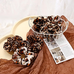 Mirlern leopard velvet scrunchies worn in a ponytail, gentle grip for versatile styling.