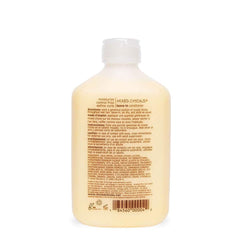 Mixed Chicks Leave-In bottle dispense shows easy, even application for frizz control.