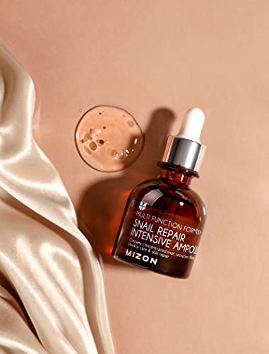 MIZON Snail Ampoule dropper in use for precise application.