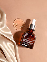 MIZON Snail Ampoule dropper in use for precise application.
