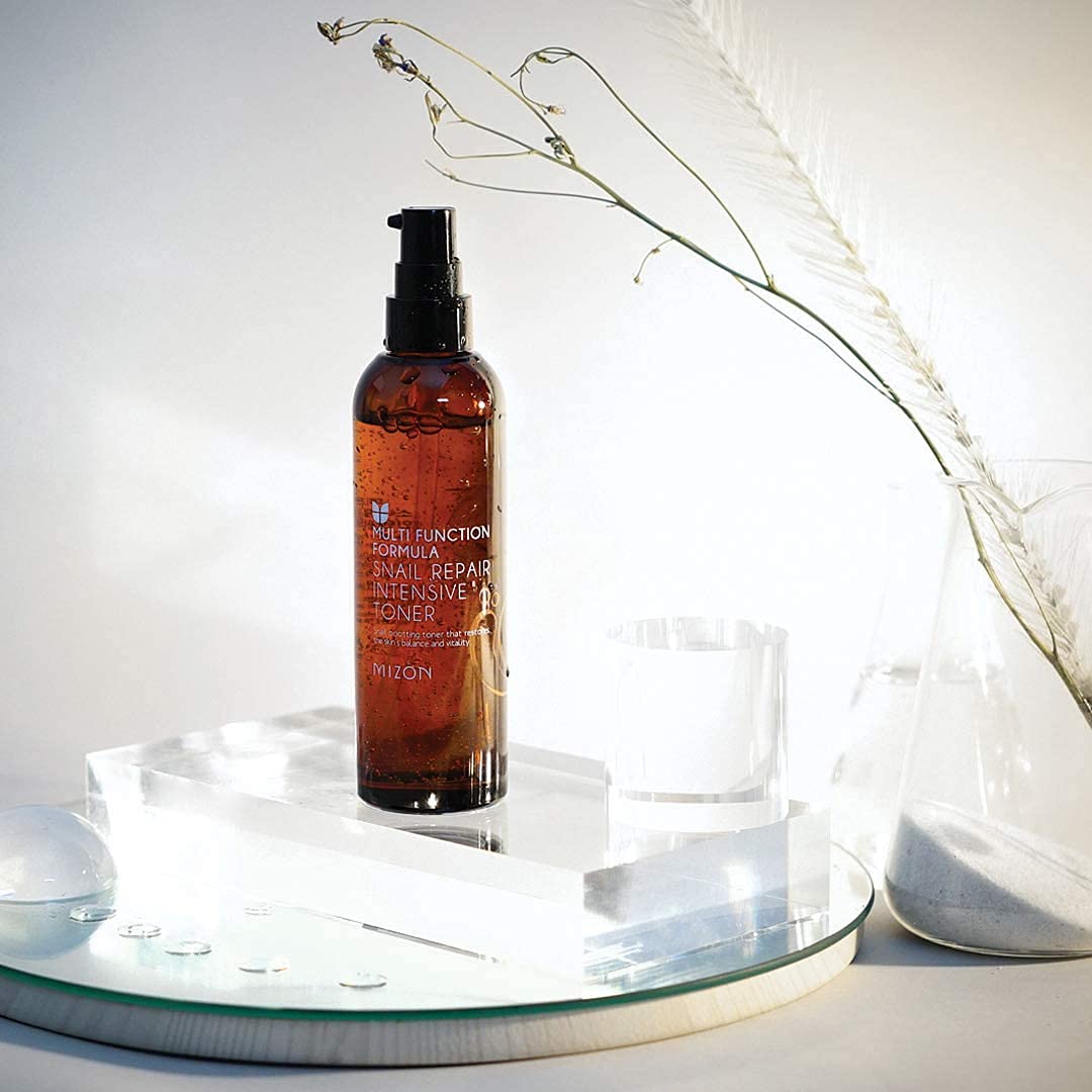 MIZON Snail Repair Toner applied on skin for a smooth, hydrated feel.