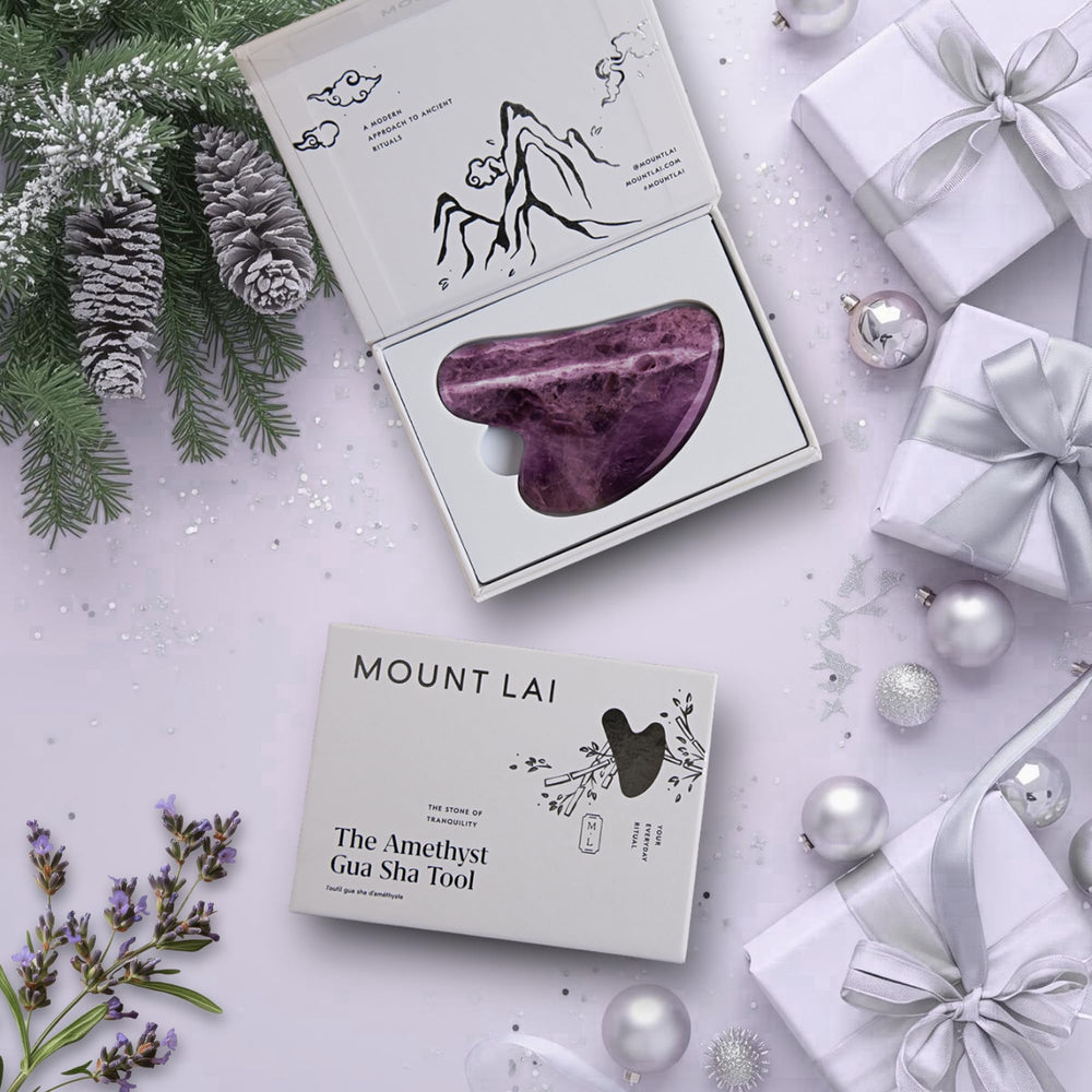 Mount Lai Amethyst Gua Sha on skin demonstrates smooth glide for contouring.