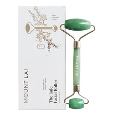 Mount Lai De-Puffing Jade Roller in hand for soothing self-care.