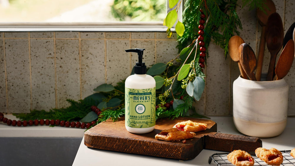 Application scene of Mrs. Meyer's Iowa Pine lotion emphasizing pine scent.