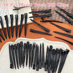 Mythos hair clip held in hand demonstrates portable styling tool.