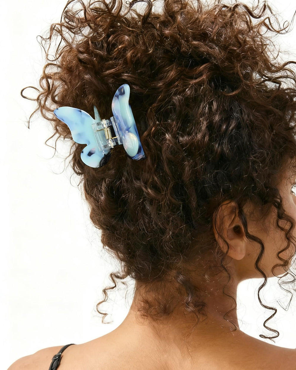 NAISIER butterfly hair clips in use—holding a small section for updo.