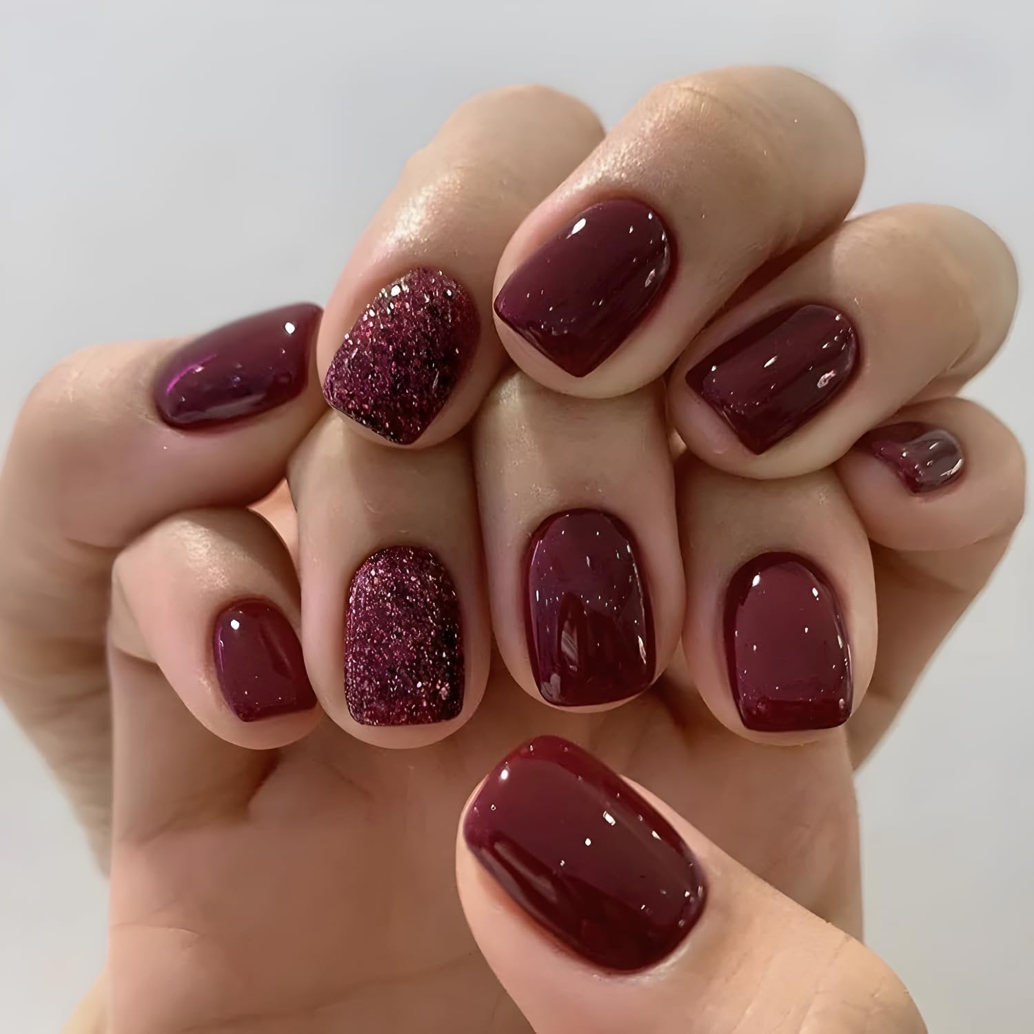 Namrec red press-on nails glitter design close-up with glossy red finish for quick at-home glam