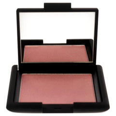NARS Orgasm blush swatch on skin demonstrates buildable color with radiant finish.