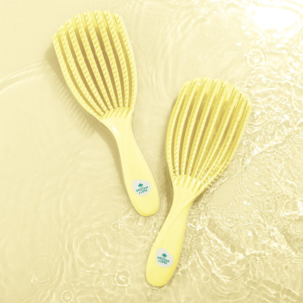 Nature Spell FlexiFlow Detangling Brush in sink shows easy hair removal.