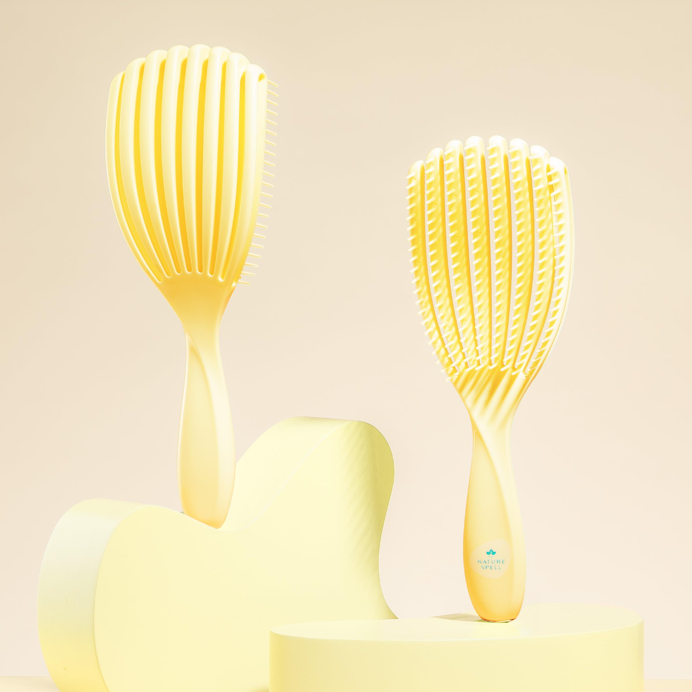 Nature Spell FlexiFlow Detangling Brush flex-technology close-up highlights adaptive strands.