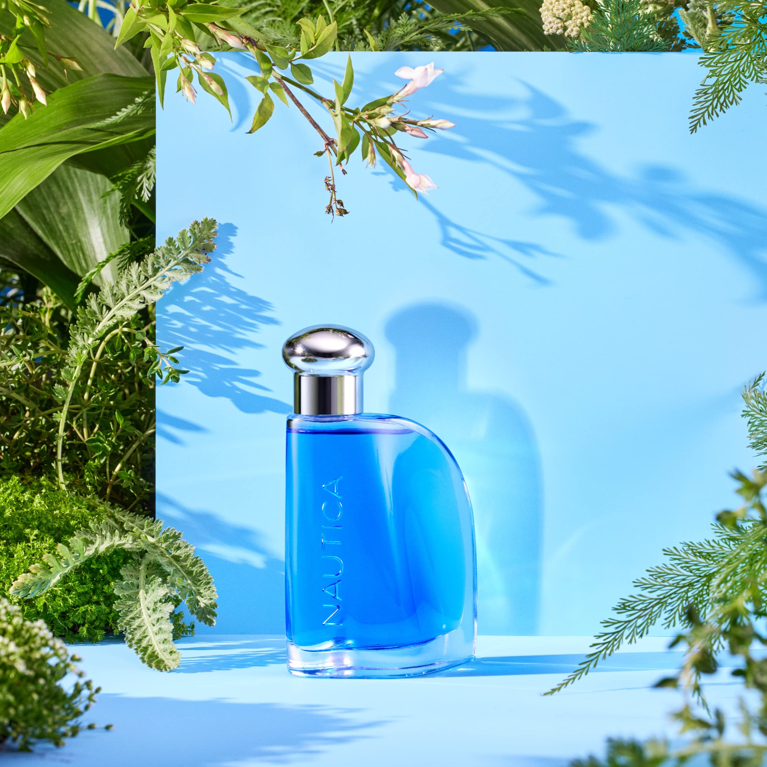 Nautica Blue EDT bottle in hand for quick refresh before a meeting