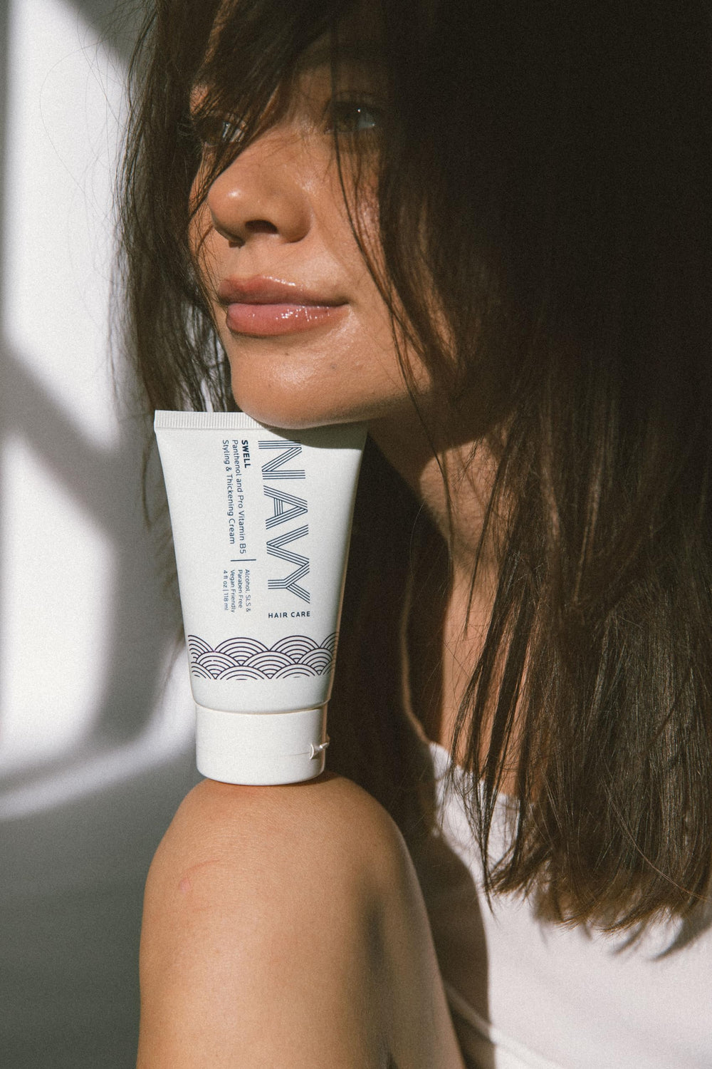 Swell Thickening Cream being dispensed smoothly for precise styling with soft hold.