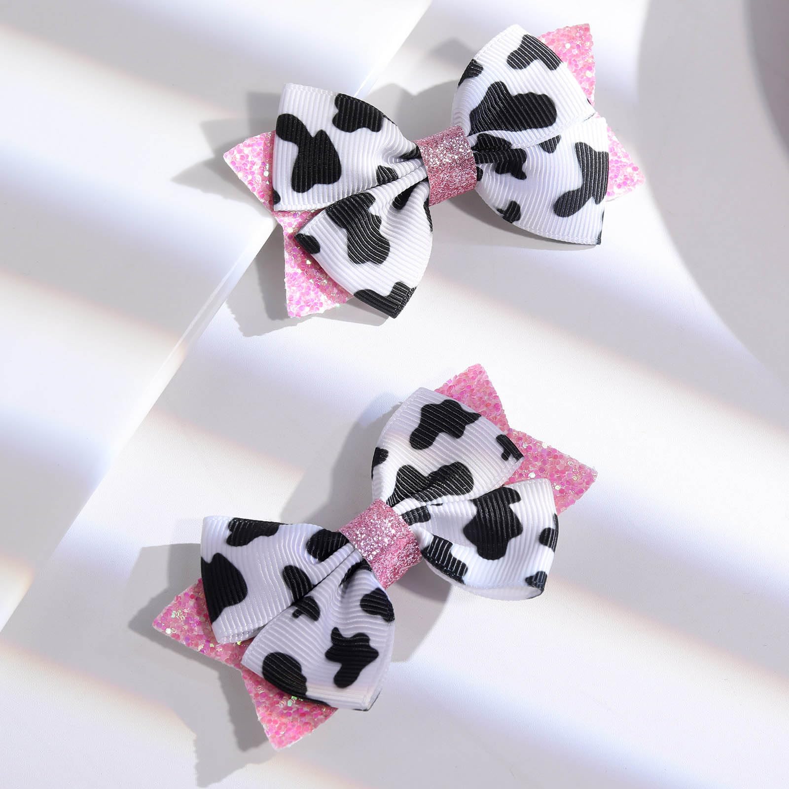NCMAMA chic cow-print bow used in family photos for festive coordinated styling.