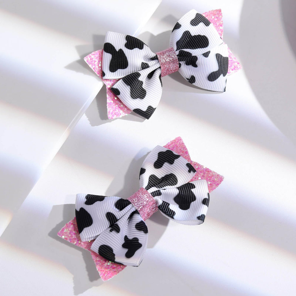 NCMAMA chic cow-print bow used in family photos for festive coordinated styling.