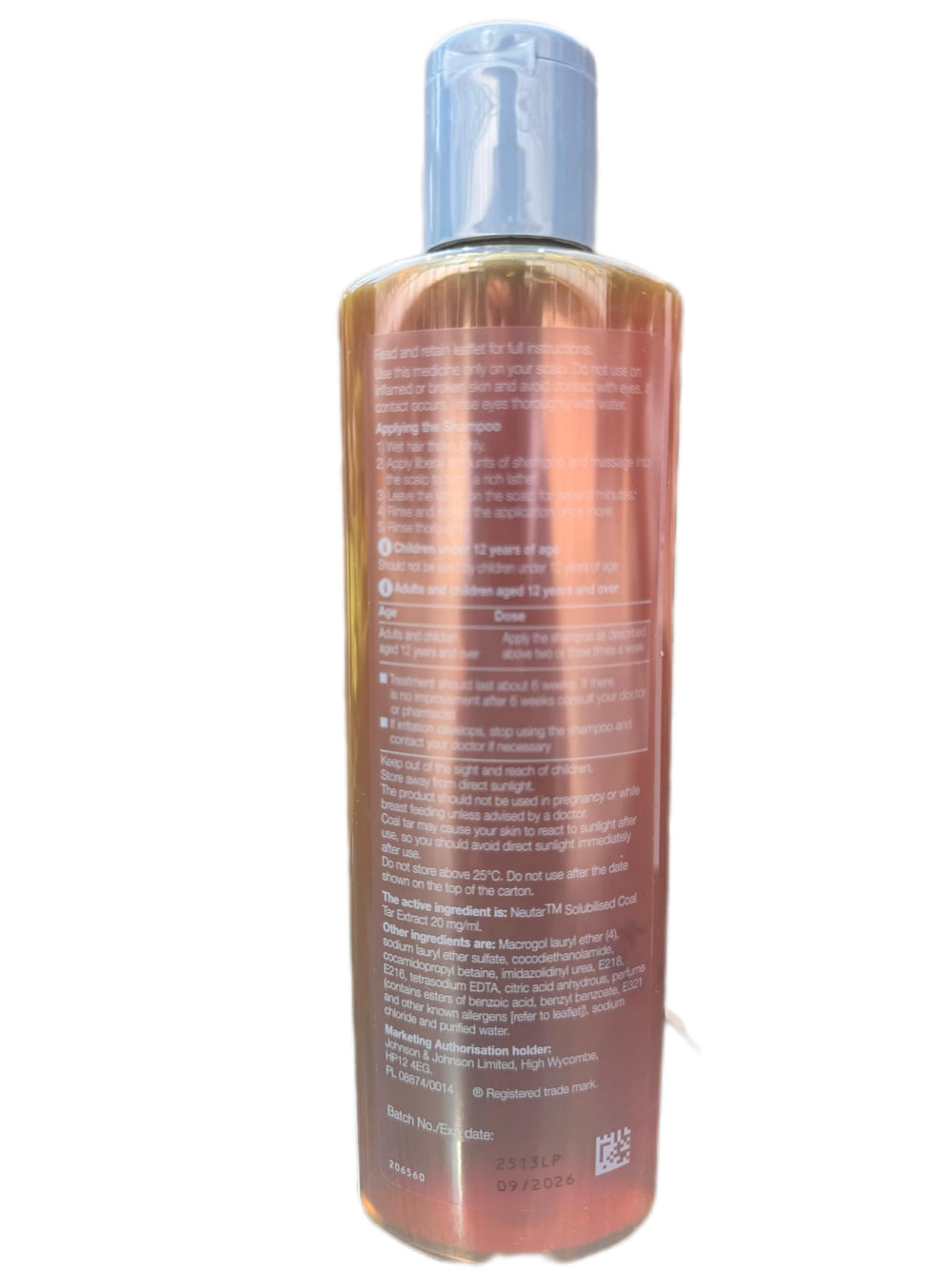 Neutrogena T-Gel shampoo lather close-up shows rich foam for dandruff control.