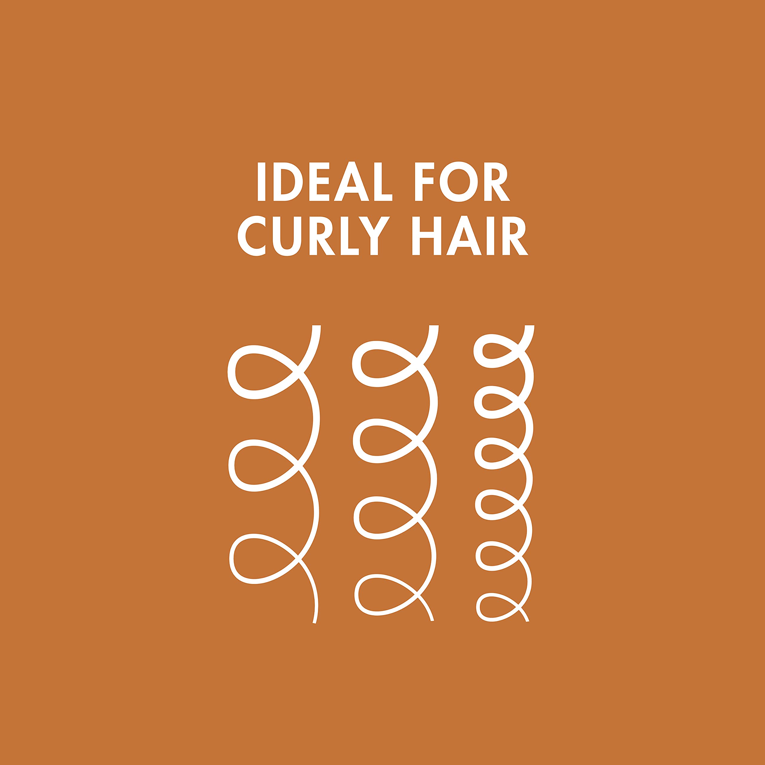 Nexxus Curl Define applying the leave-in to damp curls for frizz control.