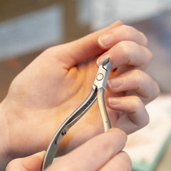 Nghia Cuticle Nipper D-04 hand-use photo showing ergonomic grip and control.