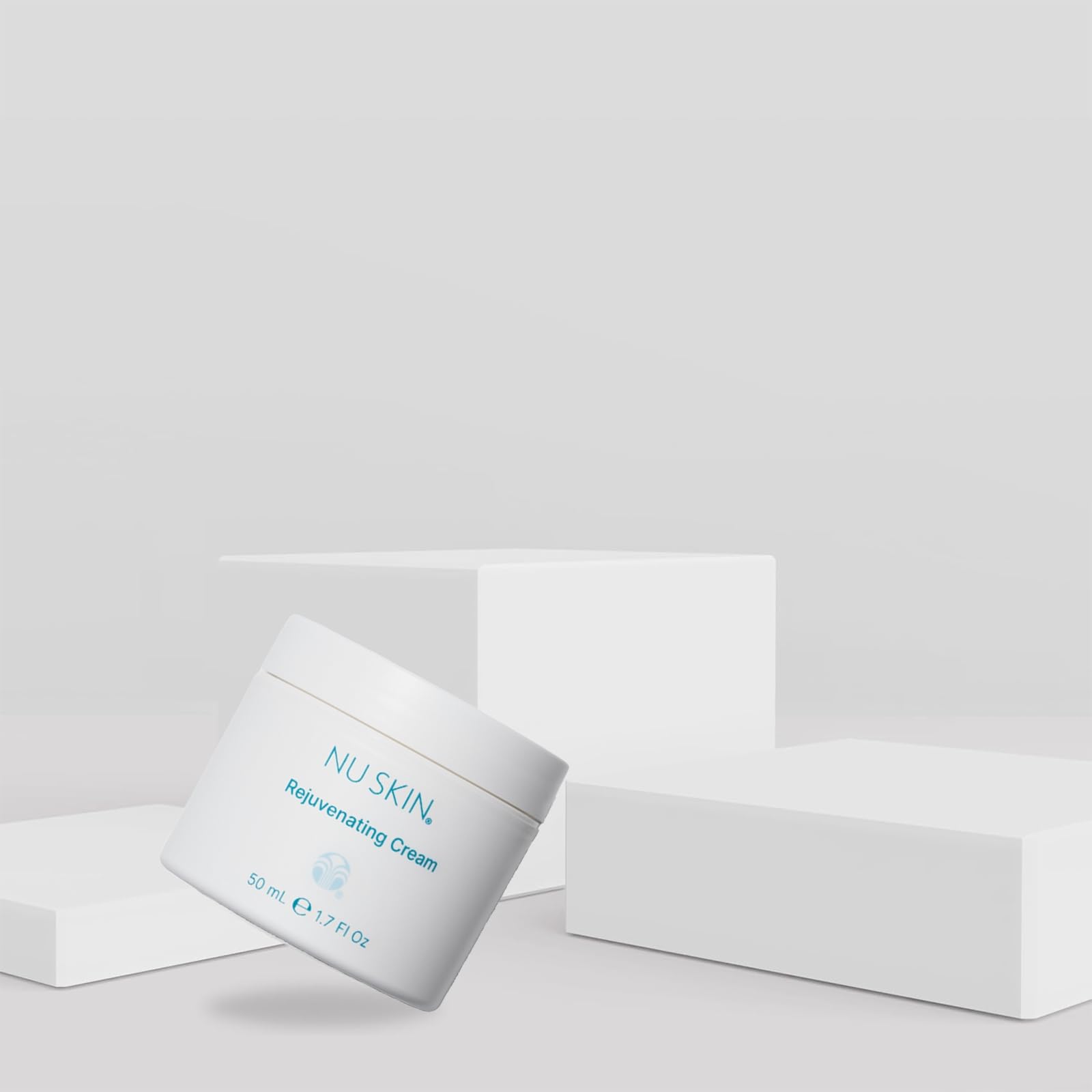 Nu Skin Rejuvenating Cream texture swirl demonstrates quick-absorbing, non-greasy hydration.