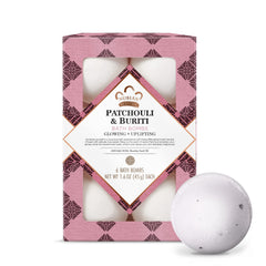 Nubian Heritage Patchouli Buriti bathbomb dissolving in water for a soothing soak.