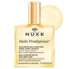 Nuxe Huile Prodigieuse bottle pouring for quick, multitask hydrating care.