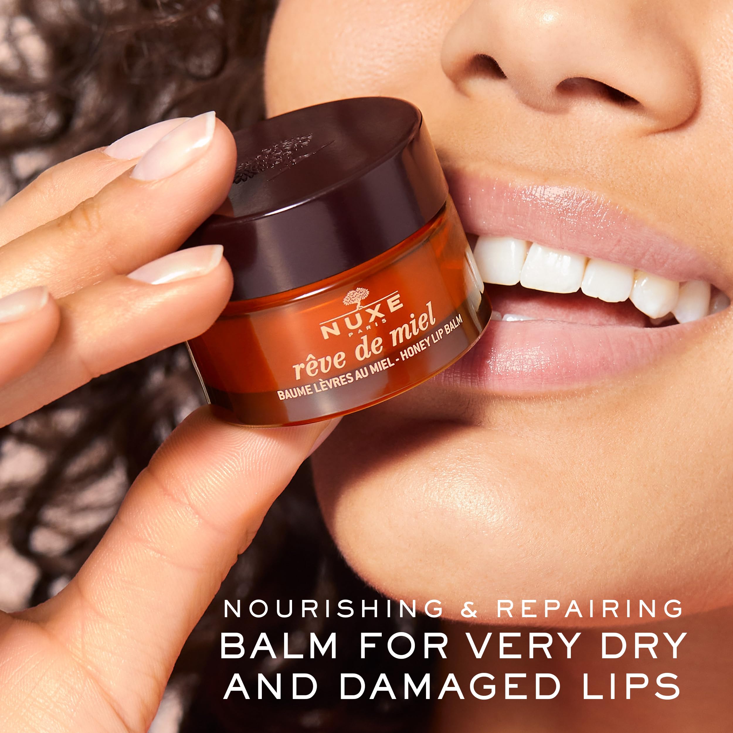 NUXE Rêve de Miel balm texture on finger shows melt-away hydration.