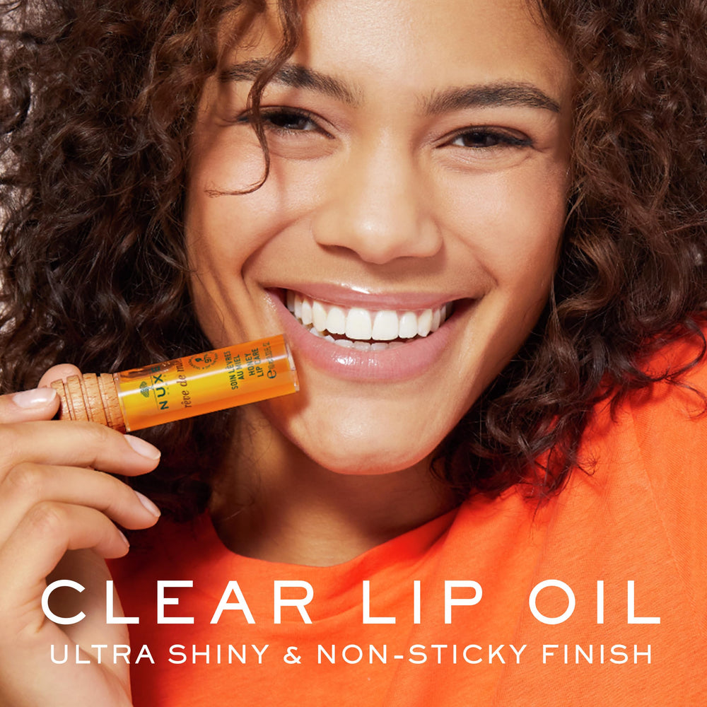 Nuxe Rêve de Miel lip gloss close-up reveals glassy texture and nourishing feel.