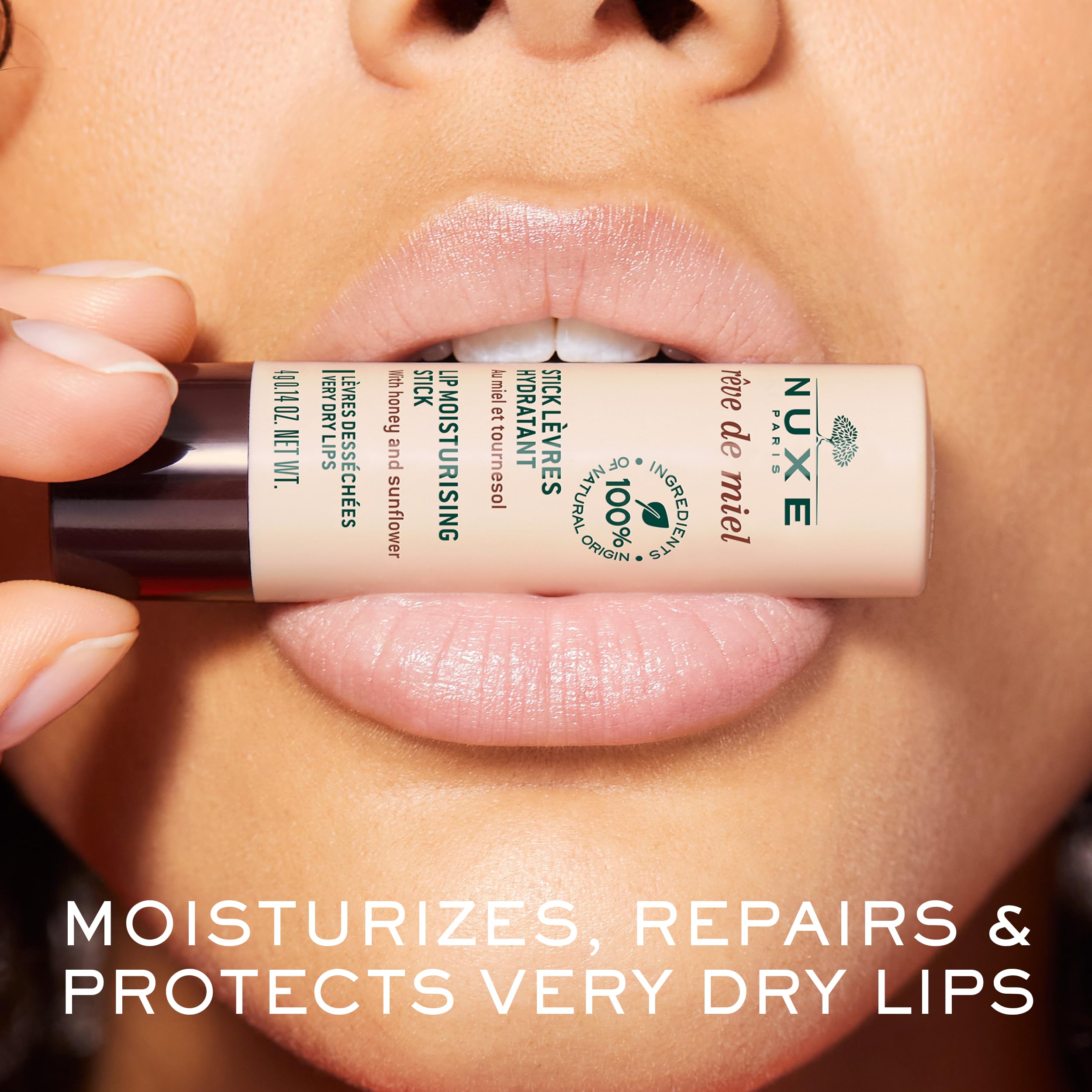 Nuxe Réve de Miel lip stick in hand for smooth glide and comfort.